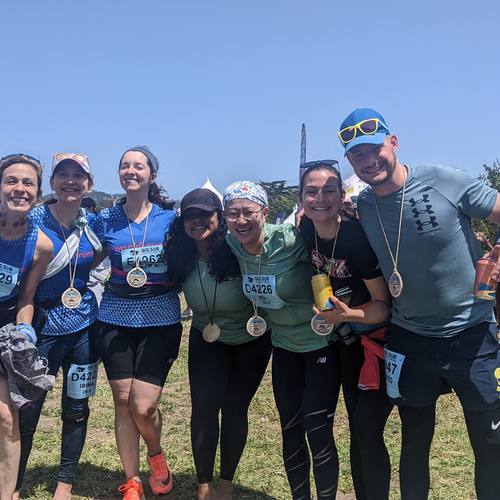 Club members with finisher medals celebrating together after a race