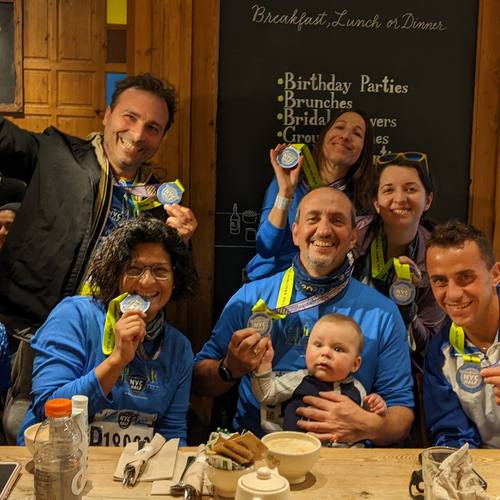 Team members with medals sharing breakfast after a run