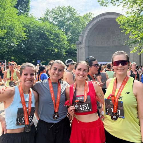 Teammates with medals at the Central Park bandshell
