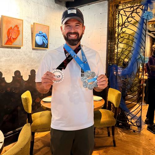 A club member showing his TCS London Marathon medal